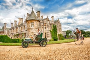 Palace House Beaulieu with vintage car and penny farthing in foreground