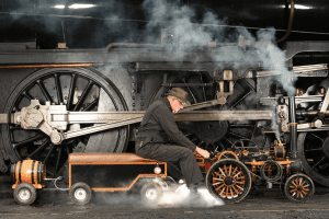 Photo of man repairing vintage engine